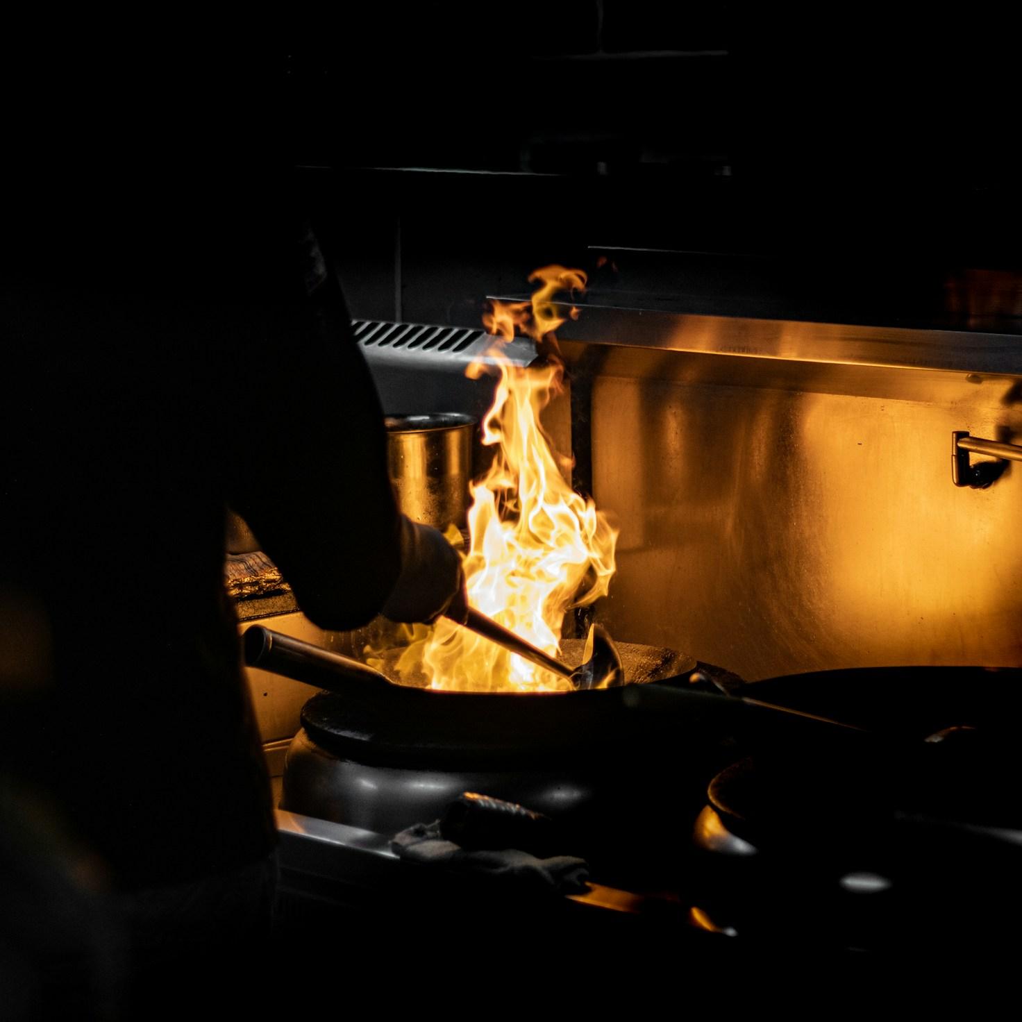 Community members collaborating in a modern kitchen space, sharing recipes and cooking techniques